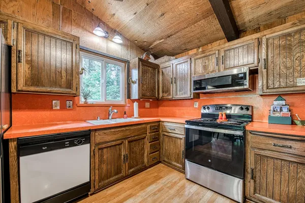 a kitchen with stainless steel appliances granite countertop a sink and stove top oven