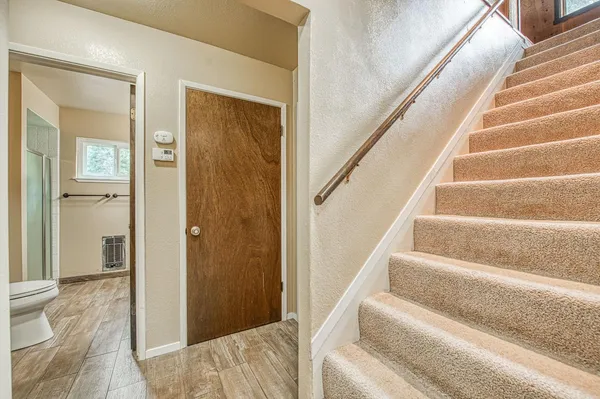 a bedroom with a bed and a flat tv screen on dresser