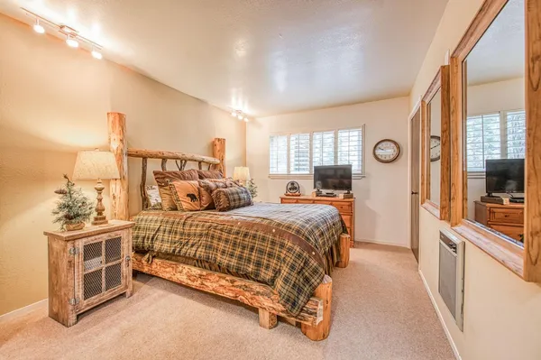 a bedroom with a large bed and a closet