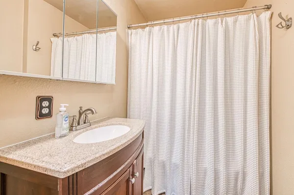 a bedroom with bed tv and window