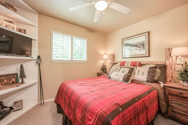 a bed sitting in a bedroom and a large mirror