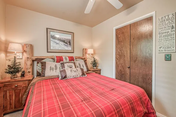 a bedroom with a bed and a chandelier