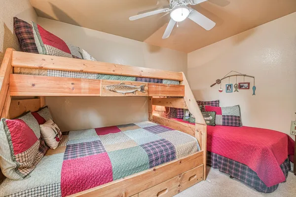 a front view of a house with a yard and green space