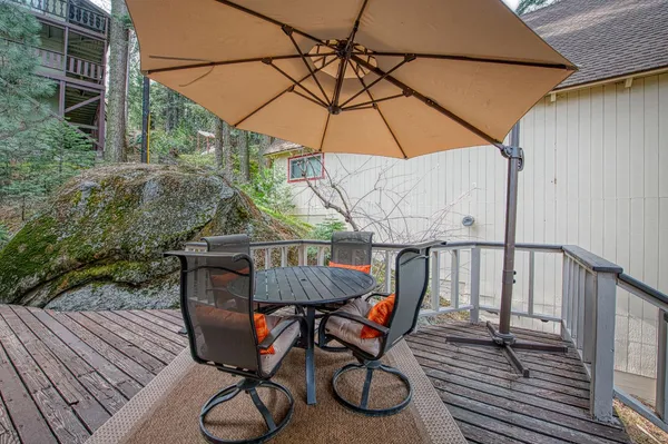 a view of balcony with wooden floor and outdoor seating