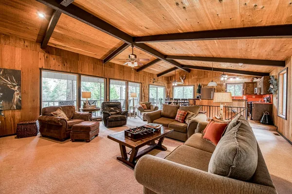 a living room with furniture city view and large windows