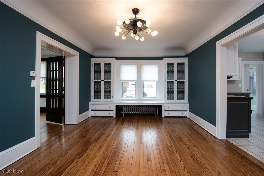 7003 Brecksville Road Independence, OH 44131 - Photo 21 of 35 Unfurnished dining area with plenty of natural light, dark wood finished floors, and a chandelier