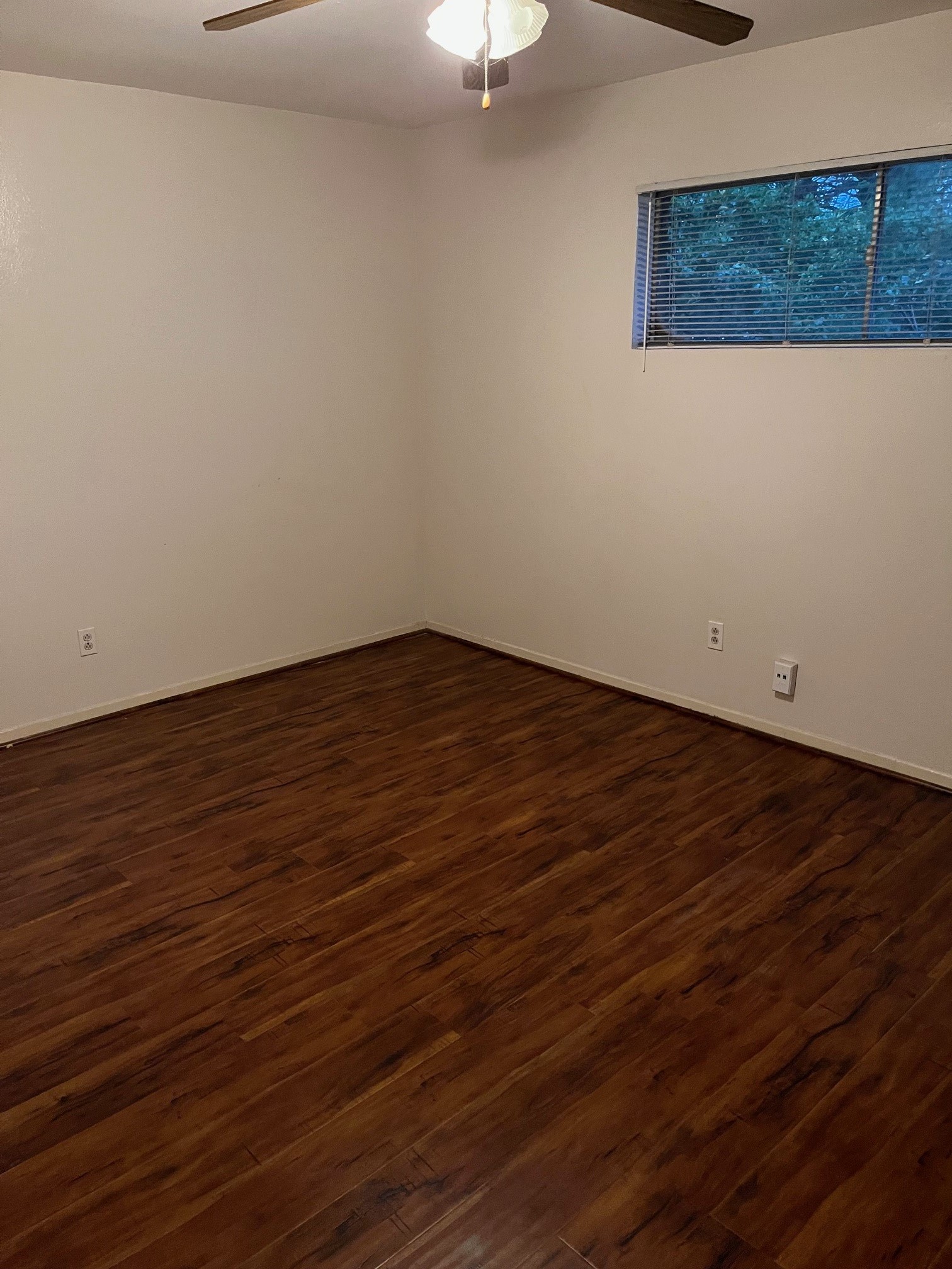 3938 West Alabama Street, Unit 12 Houston, TX 77027 - Photo 20 of 25 Bedroom with wood-look flooring, ceiling fan & natural light from window.