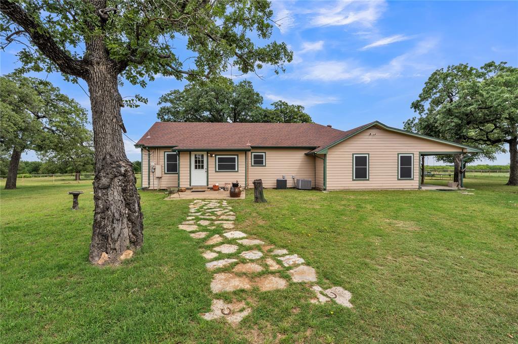 209 Dixie Road Millsap, TX 76066 - Photo 1 of 31 a front view of a house with a garden