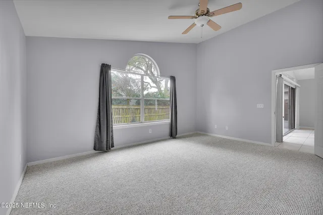 a bedroom with a bed couches and window