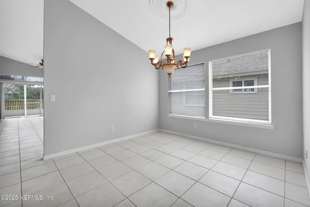 a view of a chandelier fan and entryway
