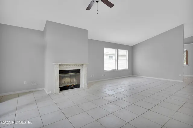 a view of an empty room with a fireplace