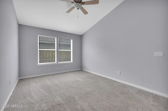 an empty room with windows and closet