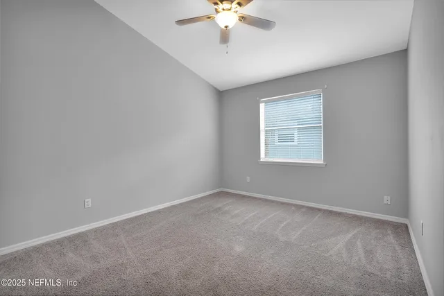 a view of a room with a large window and a chandelier