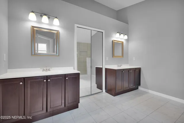a bathroom with a sink vanity and mirror