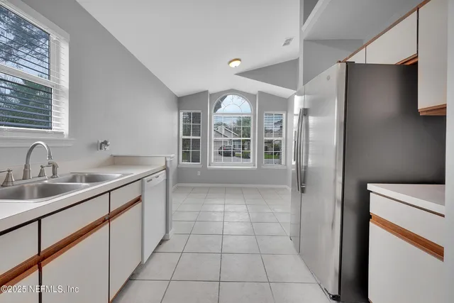 a kitchen with stainless steel appliances granite countertop a sink and cabinets with wooden floors