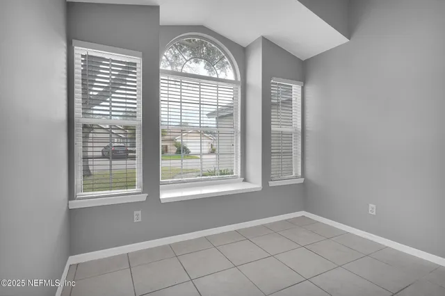a kitchen with granite countertop white cabinets stainless steel appliances and a sink