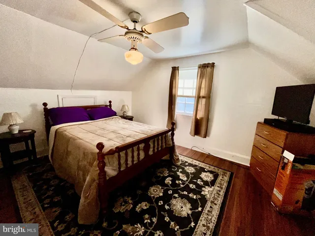 a bedroom with a bed dresser and a window