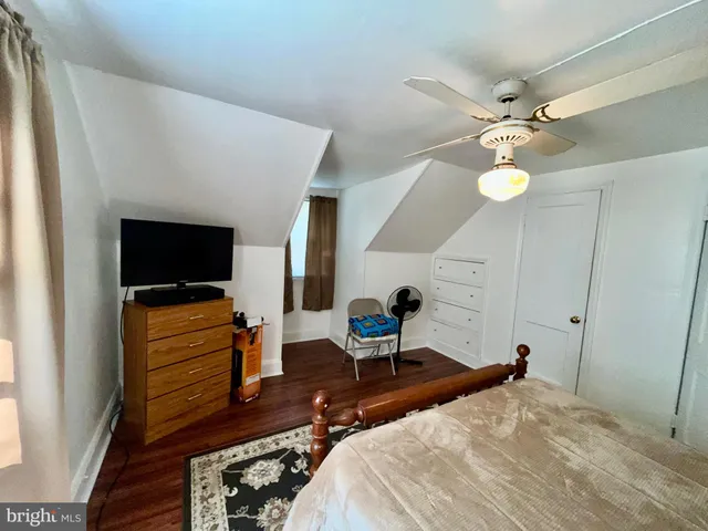 a bedroom with a bed and flat screen tv