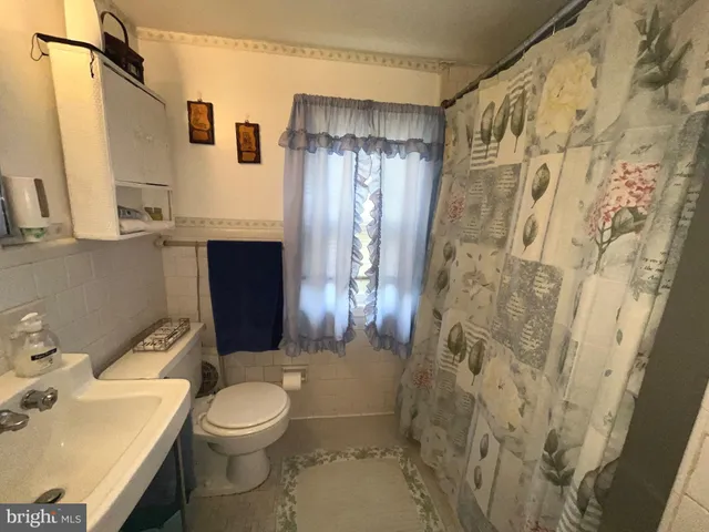 a bathroom with a toilet sink and shower