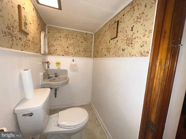 a view of kitchen with sink stove and cabinets