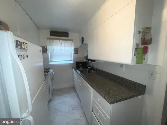 a kitchen with a refrigerator and a sink