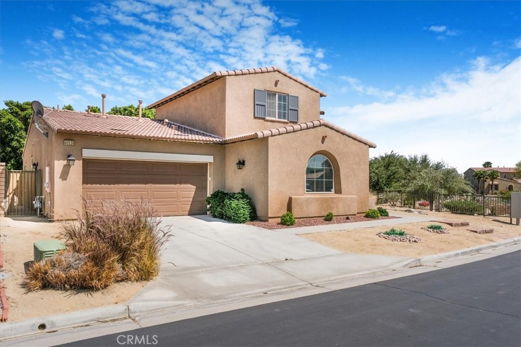 40530 Amador Drive Indio, CA 92203 - Photo 1 of 59 a front view of a house with a yard