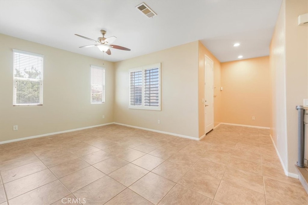 40530 Amador Drive Indio, CA 92203 - Photo 12 of 59 a view of an empty room with windows and chandelier fan
