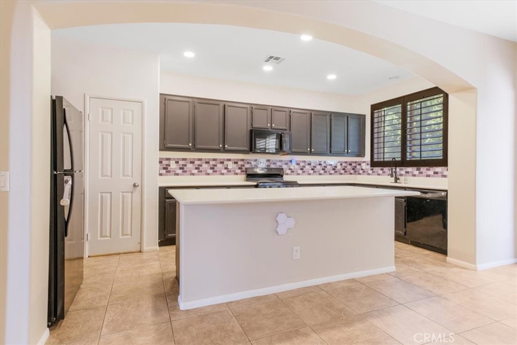40530 Amador Drive Indio, CA 92203 - Photo 21 of 59 a kitchen with stainless steel appliances granite countertop a stove a refrigerator and a oven