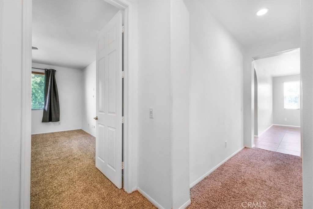 40530 Amador Drive Indio, CA 92203 - Photo 29 of 59 a view of a hallway with bathroom and wooden floor
