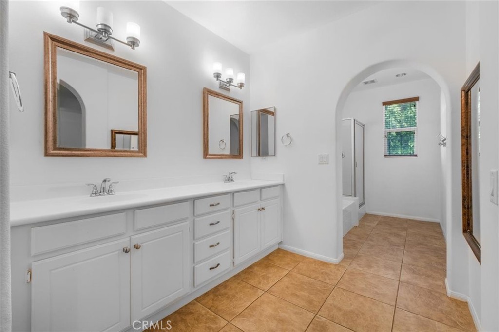 40530 Amador Drive Indio, CA 92203 - Photo 33 of 59 a spacious bathroom with a double vanity sink and a mirror