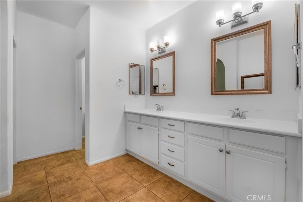 40530 Amador Drive Indio, CA 92203 - Photo 36 of 59 a bathroom with double vanity sink two mirror and a