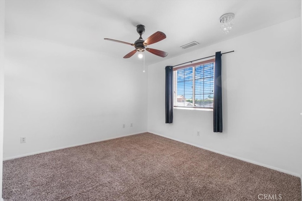 40530 Amador Drive Indio, CA 92203 - Photo 44 of 59 a view of a room with a ceiling fan and a window
