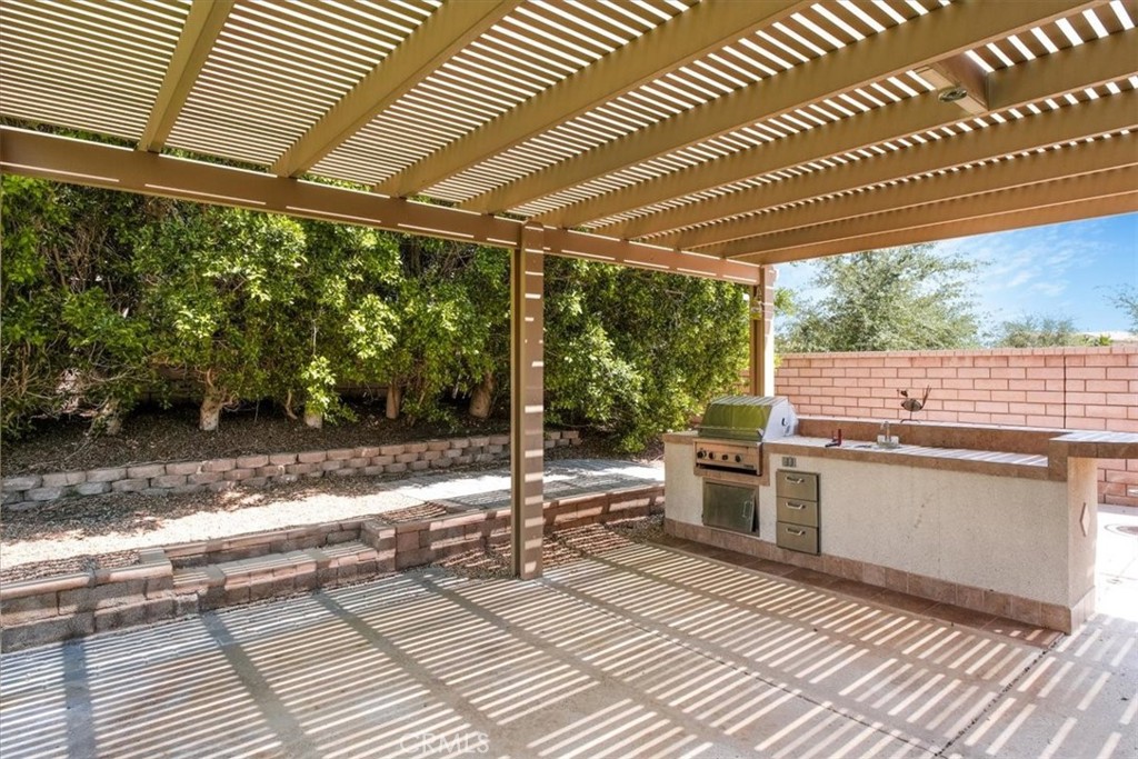 40530 Amador Drive Indio, CA 92203 - Photo 53 of 59 a view of a patio with a table and chairs next to a yard