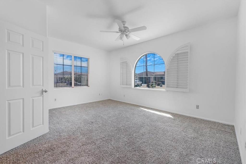 40530 Amador Drive Indio, CA 92203 - Photo 6 of 59 an empty room with a window and a ceiling fan