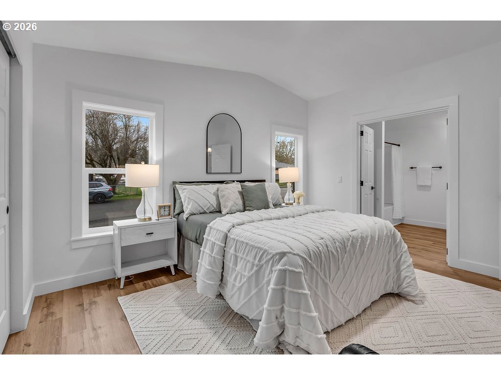 241 Northwest Wade Street Estacada, OR 97023 - Photo 20 of 45 a bedroom with a bed and wooden floor