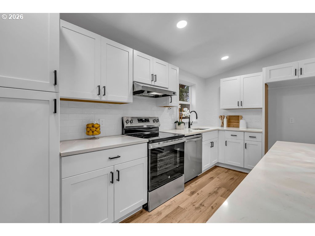 241 Northwest Wade Street Estacada, OR 97023 - Photo 26 of 45 a kitchen with cabinets stainless steel appliances and wooden floor
