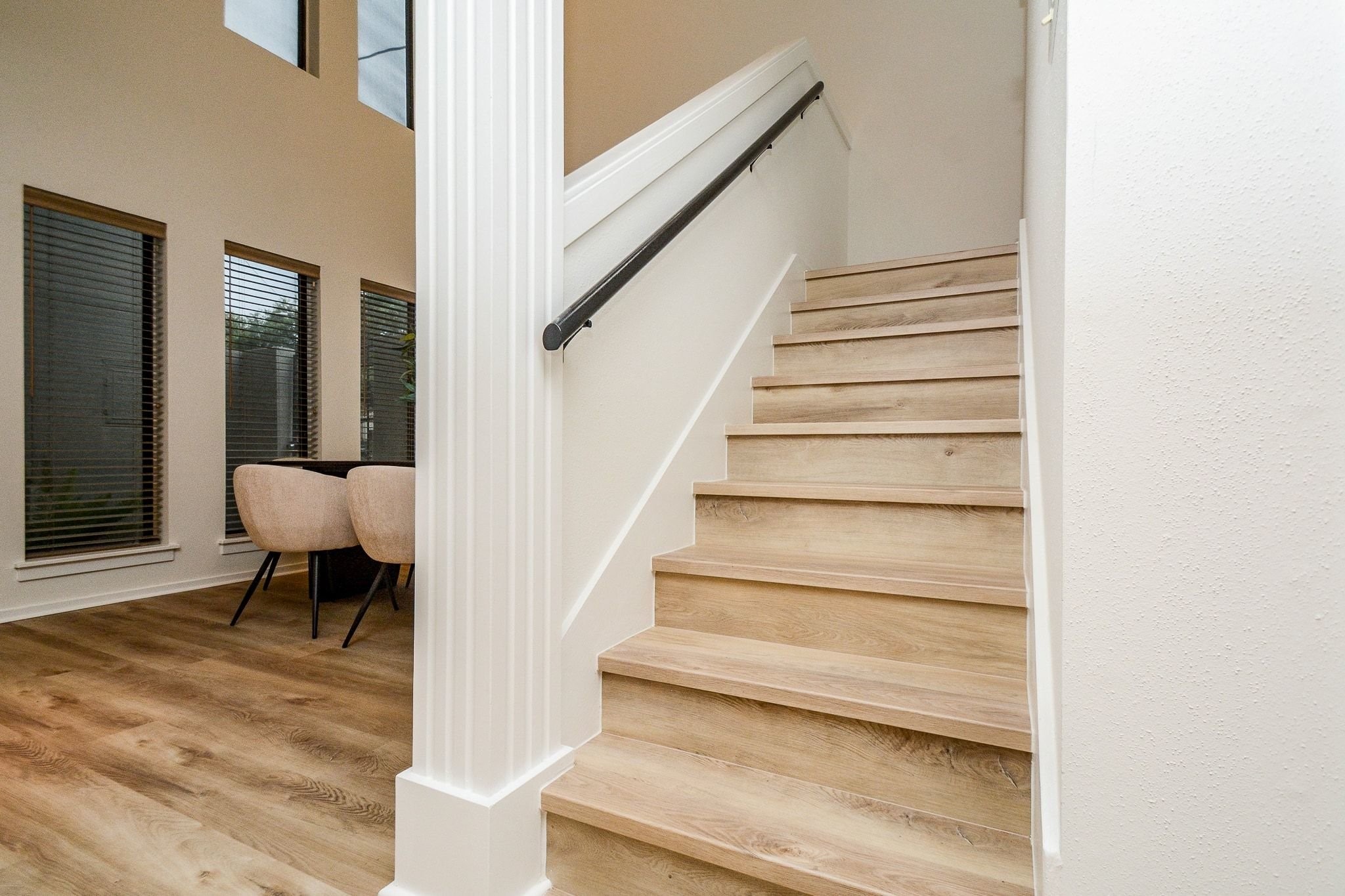 820 Harold Street Houston, TX 77006 - Photo 14 of 33 Wood-look treads and a sleek matte black handrail make a clean statement on the way up to the second floor.