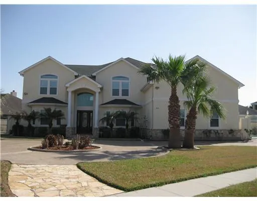 a front view of multiple houses with yard