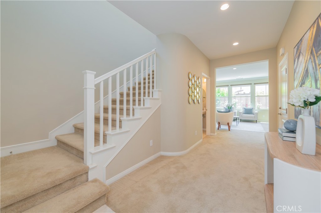 93 Rembrandt Irvine, CA 92620 - Photo 2 of 26 a view of an entryway with wooden floor leading to a furnished livingroom and windows