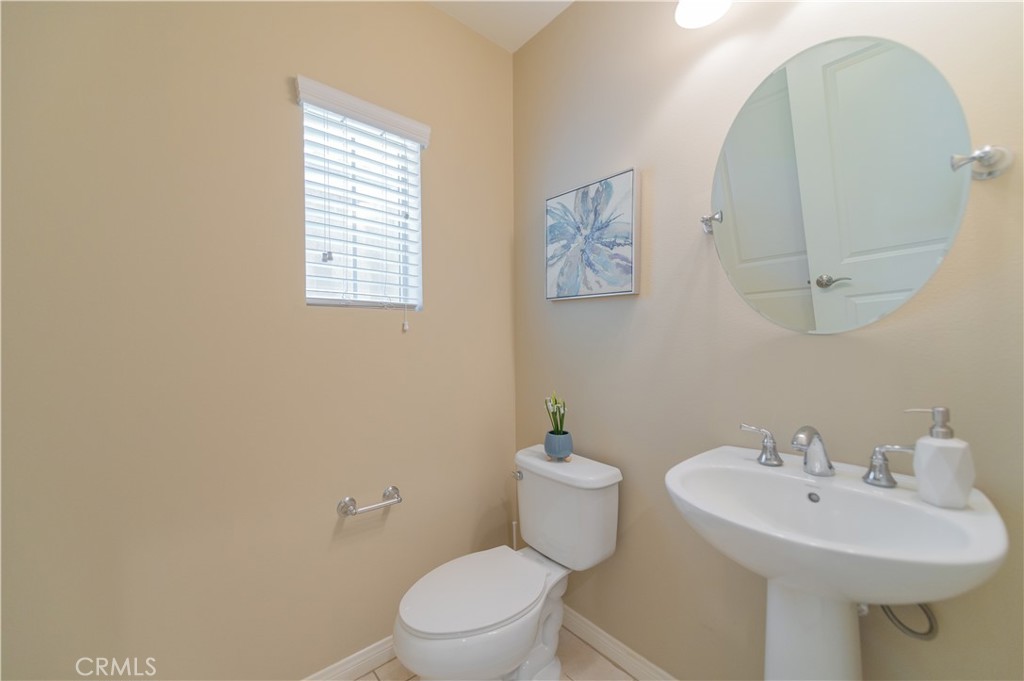 93 Rembrandt Irvine, CA 92620 - Photo 22 of 26 a bathroom with a sink mirror and toilet