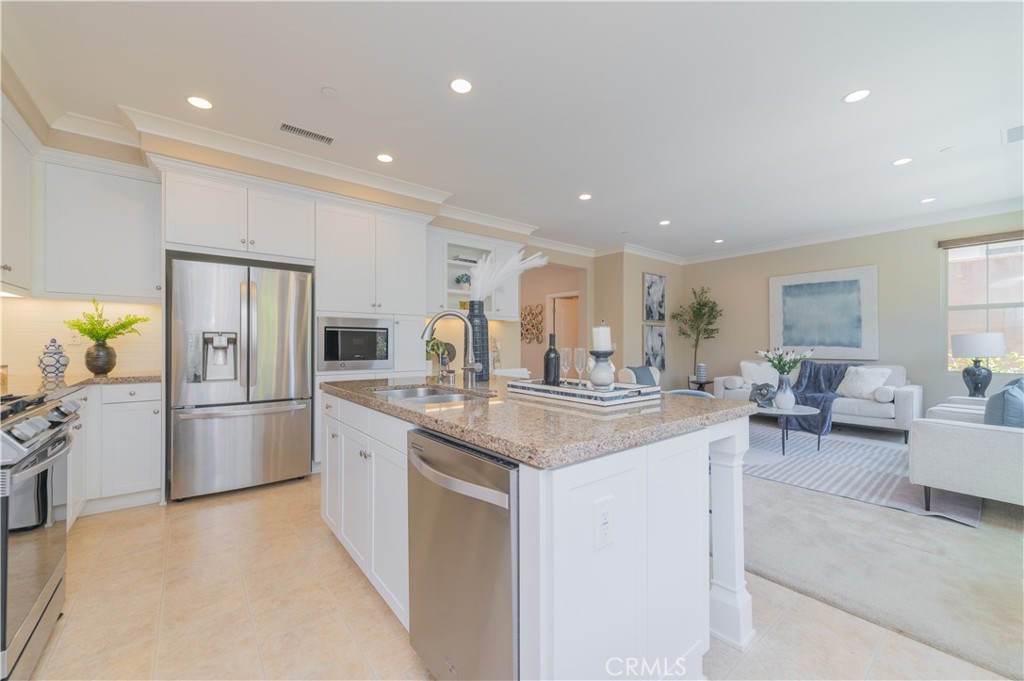 93 Rembrandt Irvine, CA 92620 - Photo 8 of 26 a kitchen with stainless steel appliances granite countertop a refrigerator and a stove top oven