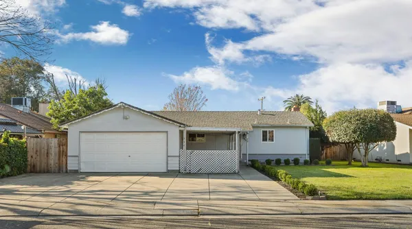 a view of a house with a yard and garage