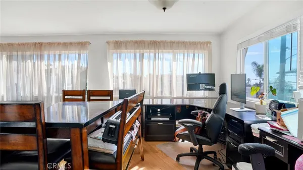 a bedroom with a bed and a flat tv screen on dresser