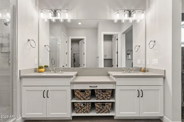 a bathroom with a granite countertop sink toilet and mirror
