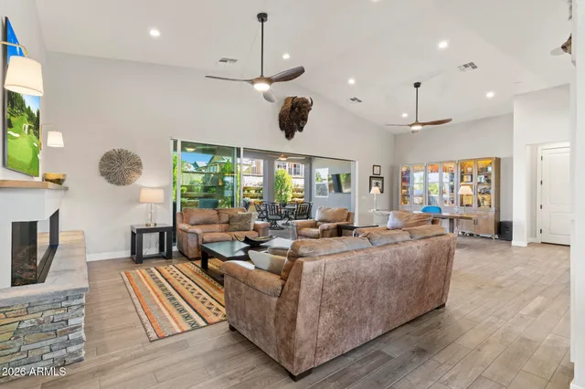 a living room with furniture a large window and a flat screen tv