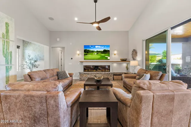 a kitchen with a chandelier and wooden cabinets