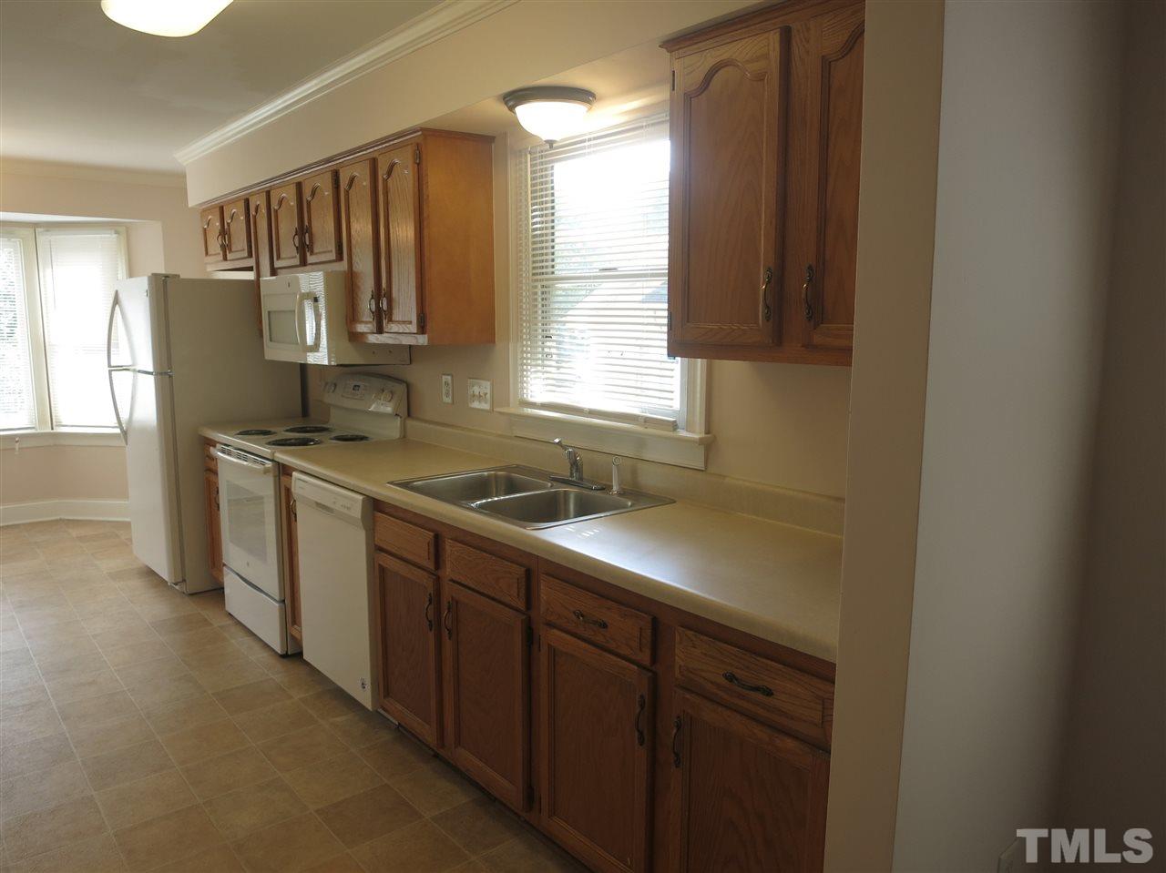 509 Brent Road Raleigh, NC 27606 - Photo 3 of 9 a kitchen with stainless steel appliances granite countertop a sink stove and refrigerator