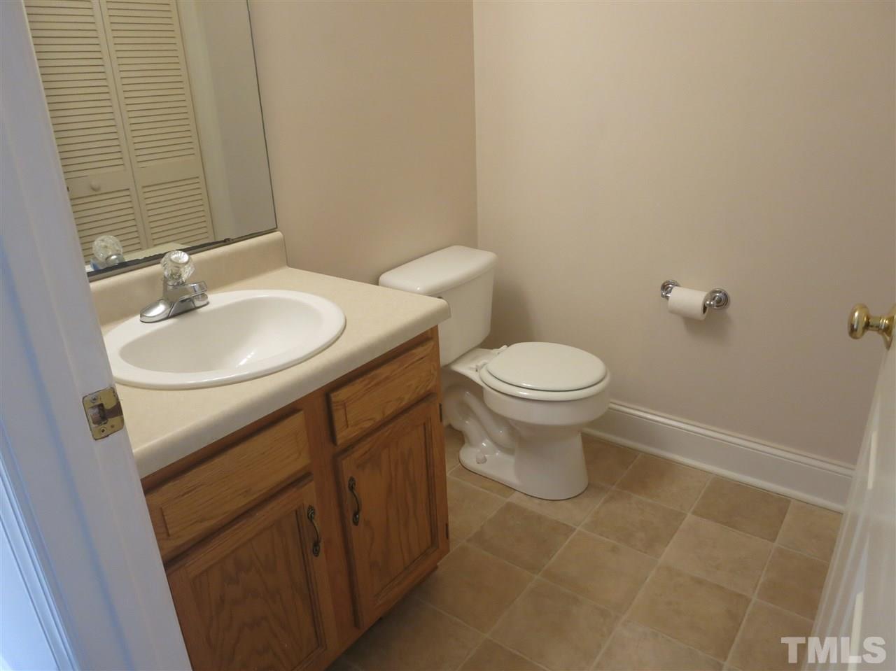 509 Brent Road Raleigh, NC 27606 - Photo 6 of 9 a bathroom with a sink toilet and a mirror