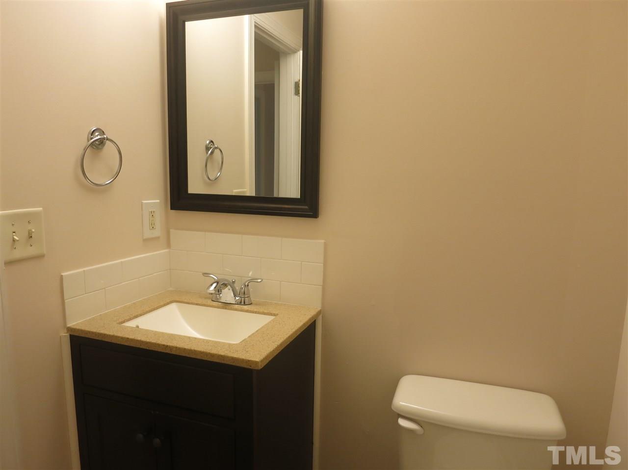 509 Brent Road Raleigh, NC 27606 - Photo 9 of 9 a bathroom with a sink and a mirror
