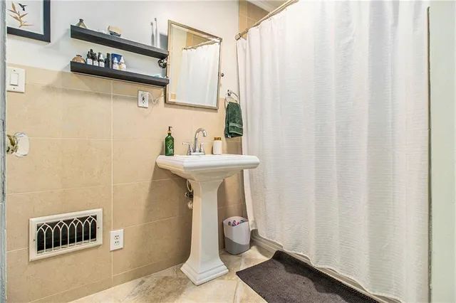 a bathroom with a sink a toilet and shower curtain